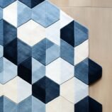 Handmade geometric hexagon rug in blue, navy, and cream, designed for modern and minimalist interiors, by Rugs Of Hindustan