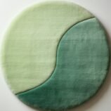Modern round green gradient area rug with yin-yang-inspired design, ideal for serene and minimalist interiors.