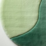 Modern round green gradient area rug with yin-yang-inspired design, ideal for serene and minimalist interiors.