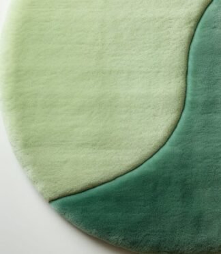 Modern round green gradient area rug with yin-yang-inspired design, ideal for serene and minimalist interiors.