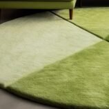 Luxurious round green gradient area rug with nature-inspired design, perfect for modern and minimalist interiors.