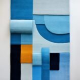 Modern geometric rectangular rug in shades of blue with bold yellow accent for contemporary interiors.