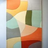 Modern abstract area rug with warm earthy tones and organic patterns, ideal for contemporary interiors.