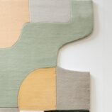 Modern geometric area rug with earthy tones and abstract patterns, perfect for stylish interiors.