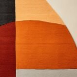 Contemporary abstract semi-circular area rug in warm earthy tones, ideal for modern and minimalist interiors.