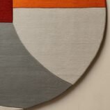 Contemporary abstract semi-circular area rug in warm earthy tones, ideal for modern and minimalist interiors.