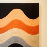 Contemporary orange wave pattern rug featuring bold shades of orange, black, and beige for modern interiors.