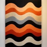 Contemporary orange wave pattern rug featuring bold shades of orange, black, and beige for modern interiors.