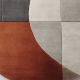 Modern geometric abstract rug with neutral beige, gray, and terracotta tones for contemporary interiors.