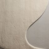 Ivory crescent moon rug featuring a lunar-inspired design in soft ivory tones for elegant modern interiors.