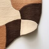 Earthy abstract rug featuring a blend of warm neutral tones in an organic pattern for contemporary interiors.