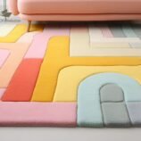 Pastel modern rug with multicolored abstract design in soft hues, enhancing a contemporary living space.