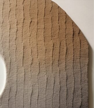 Modern gradient circular rug with beige-to-brown ombre design and unique asymmetrical cut.