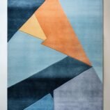 Abstract geometric rug with bold blue, orange, and yellow tones in a modern hand-tufted design.