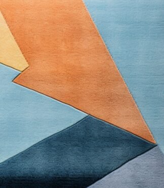 Abstract geometric rug with bold blue, orange, and yellow tones in a modern hand-tufted design.