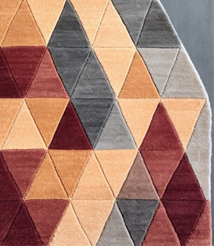 Triangular geometric rug in beige, maroon, and gray tones with a modern handcrafted design.