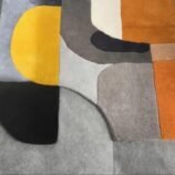 Abstract geometric runner rug in yellow, gray, and orange tones, ideal for kitchens and hallways.