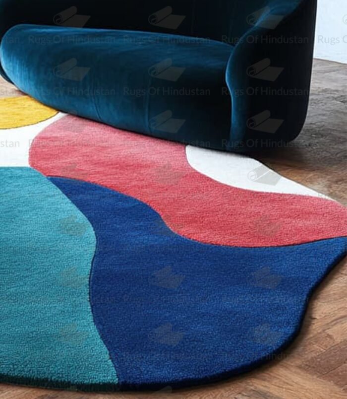 Bold multicolor rug in abstract shape under staircase and blue couch