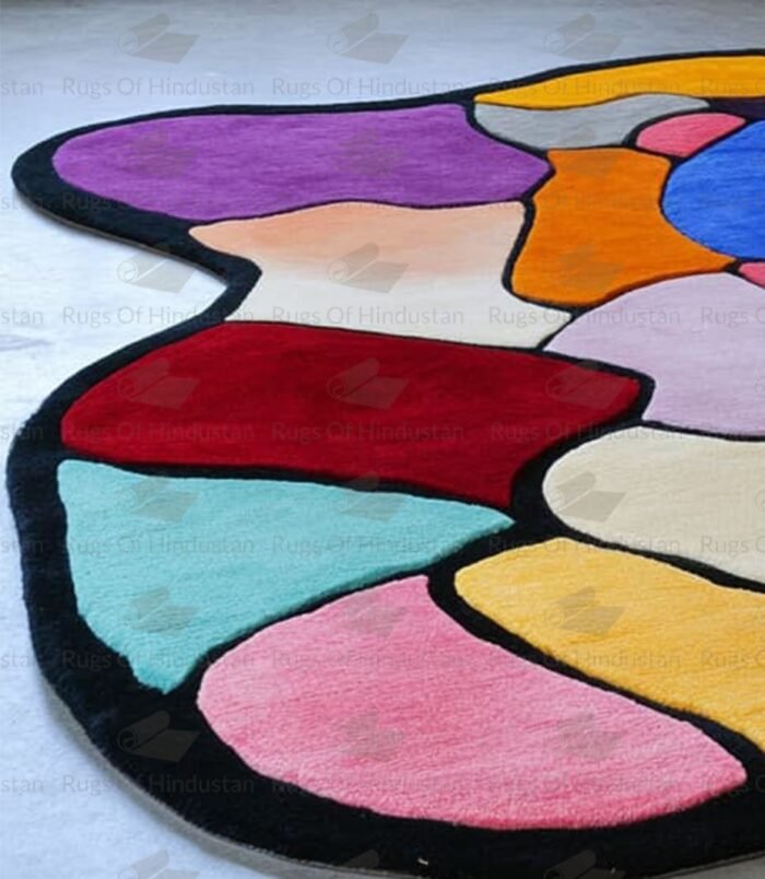 Abstract multicolor patchwork rug with black border placed in modern gallery-style room