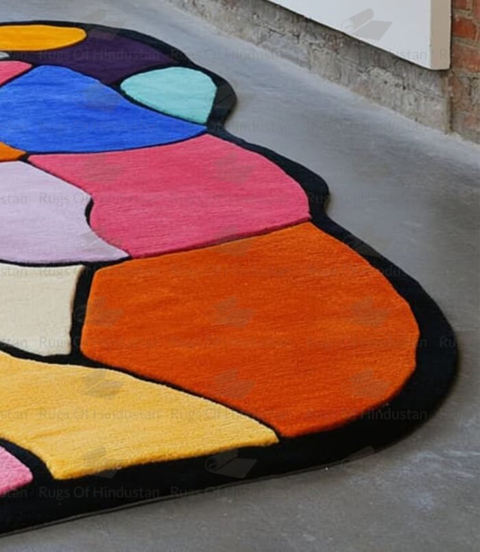 Abstract multicolor patchwork rug with black border placed in modern gallery-style room