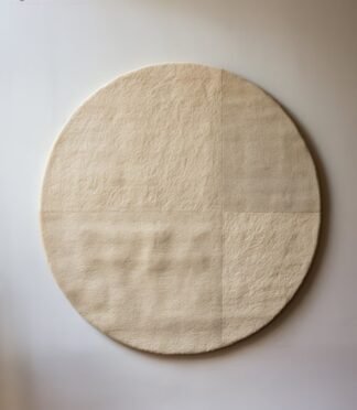 Minimalist hand-tufted round wool rug in beige with quadrant texture detailing by Rugs Of Hindustan