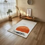 Minimalist Japandi sunrise wool rug with orange sun and black waves on cream background placed in a serene modern living room