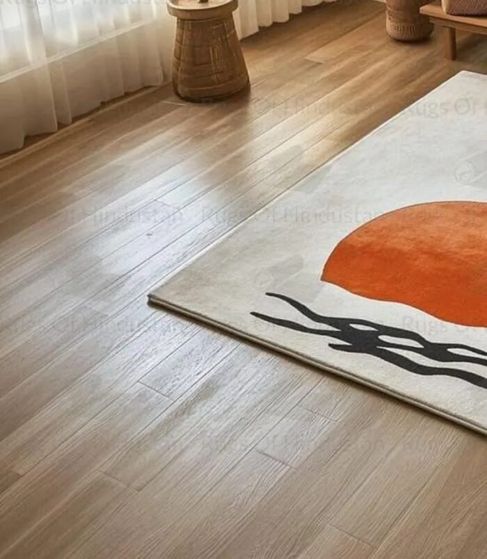 Minimalist Japandi sunrise wool rug with orange sun and black waves on cream background placed in a serene modern living room