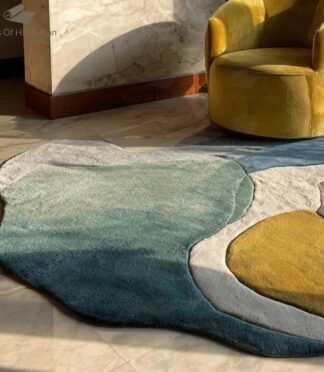 Hand-tufted abstract irregular wool rug in pastel colors with modern design in sunlight next to a yellow chair