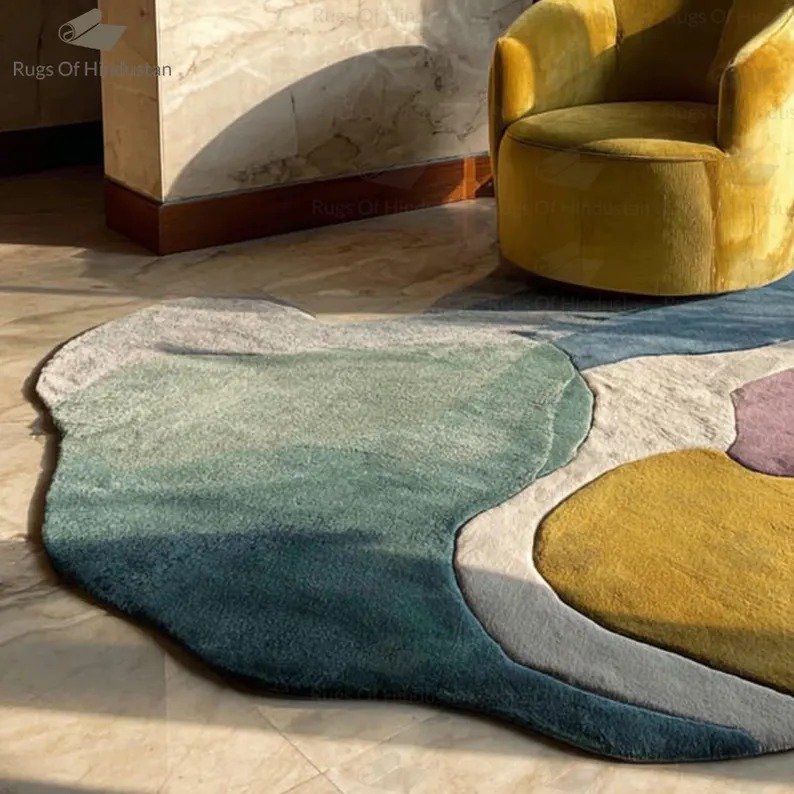 Hand-tufted abstract irregular wool rug in pastel colors with modern design in sunlight next to a yellow chair
