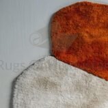 Irregular high-pile wool rug with organic color blocks in shag texture on modern white floor