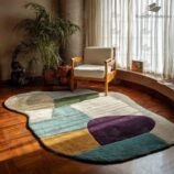 artistic multicolor wool rug with curved organic shape in modern interior