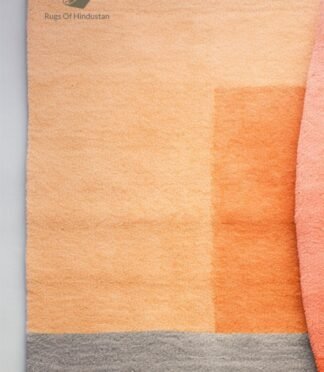 Handmade geometric abstract wool rug in warm & neutral tones, perfect for modern home decor.