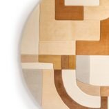 Modern artistic abstract area rug featuring a textured design with beige, gray, and black tones.