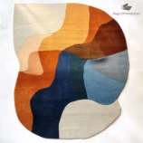 Modern abstract area rug in warm earth tones of orange, blue, and beige, handcrafted for modern interiors.