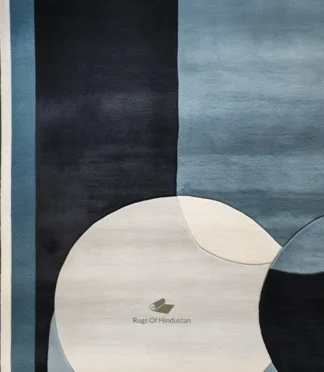 Abstract blue and black rug featuring bold geometric patterns for a contemporary interior.