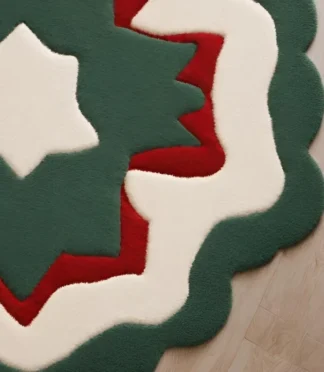 Modern star-shaped rug with green, red, and white layers, handcrafted for festive and elegant interiors.