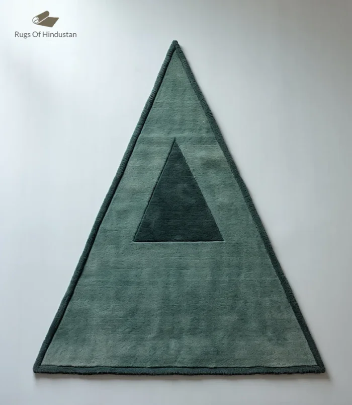 Handmade triangle wool rug in soft green with a minimalist geometric design, ideal for modern homes.