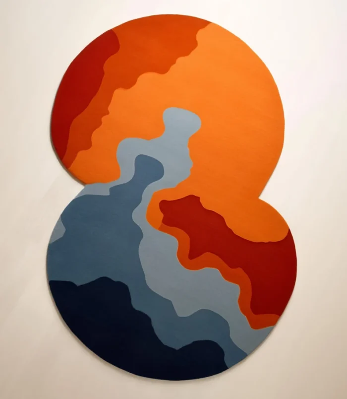 Bold abstract round area rug with vibrant orange, blue, and red hues, perfect for modern interiors.