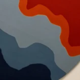 Bold abstract round area rug with vibrant orange, blue, and red hues, perfect for modern interiors.