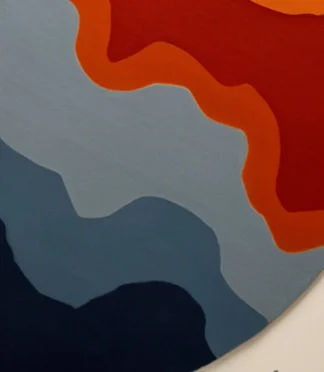 Bold abstract round area rug with vibrant orange, blue, and red hues, perfect for modern interiors.