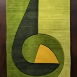 Modern geometric hand-tufted green wool area rug with abstract design for contemporary home décor.