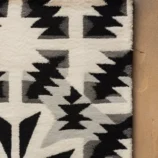 Handcrafted Southwestern black and white geometric wool rug with tribal pattern for elegant home décor.