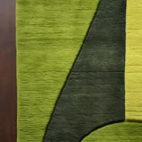 Modern geometric hand-tufted green wool area rug with abstract design for contemporary home décor.