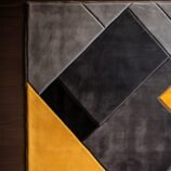 Modern geometric yellow and grey rug with bold abstract patterns for contemporary interiors.