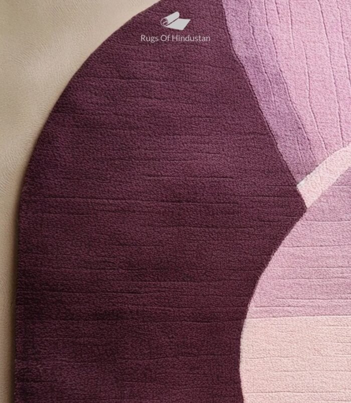 Modern oval abstract rug in shades of purple and pink with a unique artistic design